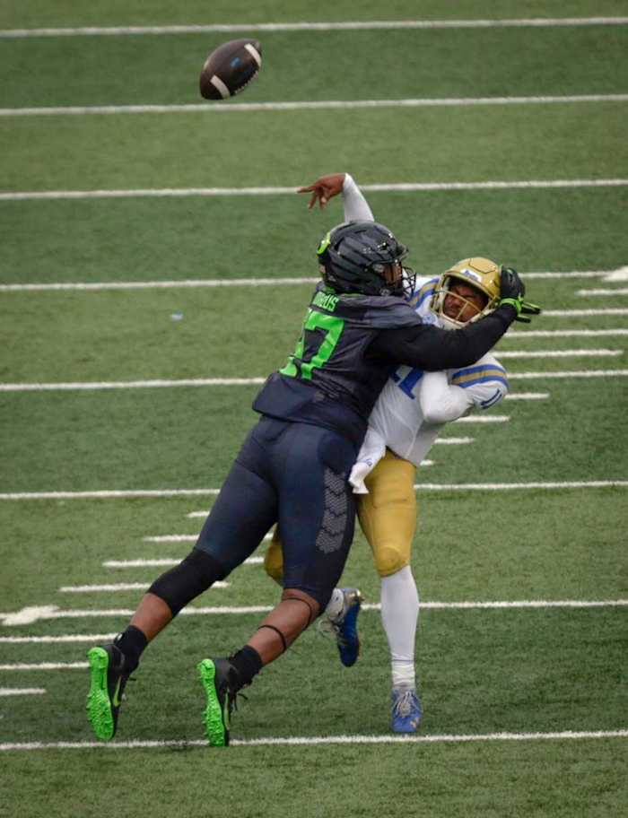 Brandon Dorlus rocks quarterback Chase Griffith late in the second quarter against UCLA. Dorlus' hit forced an interception that helped Oregon gain a slim lead going into halftime.